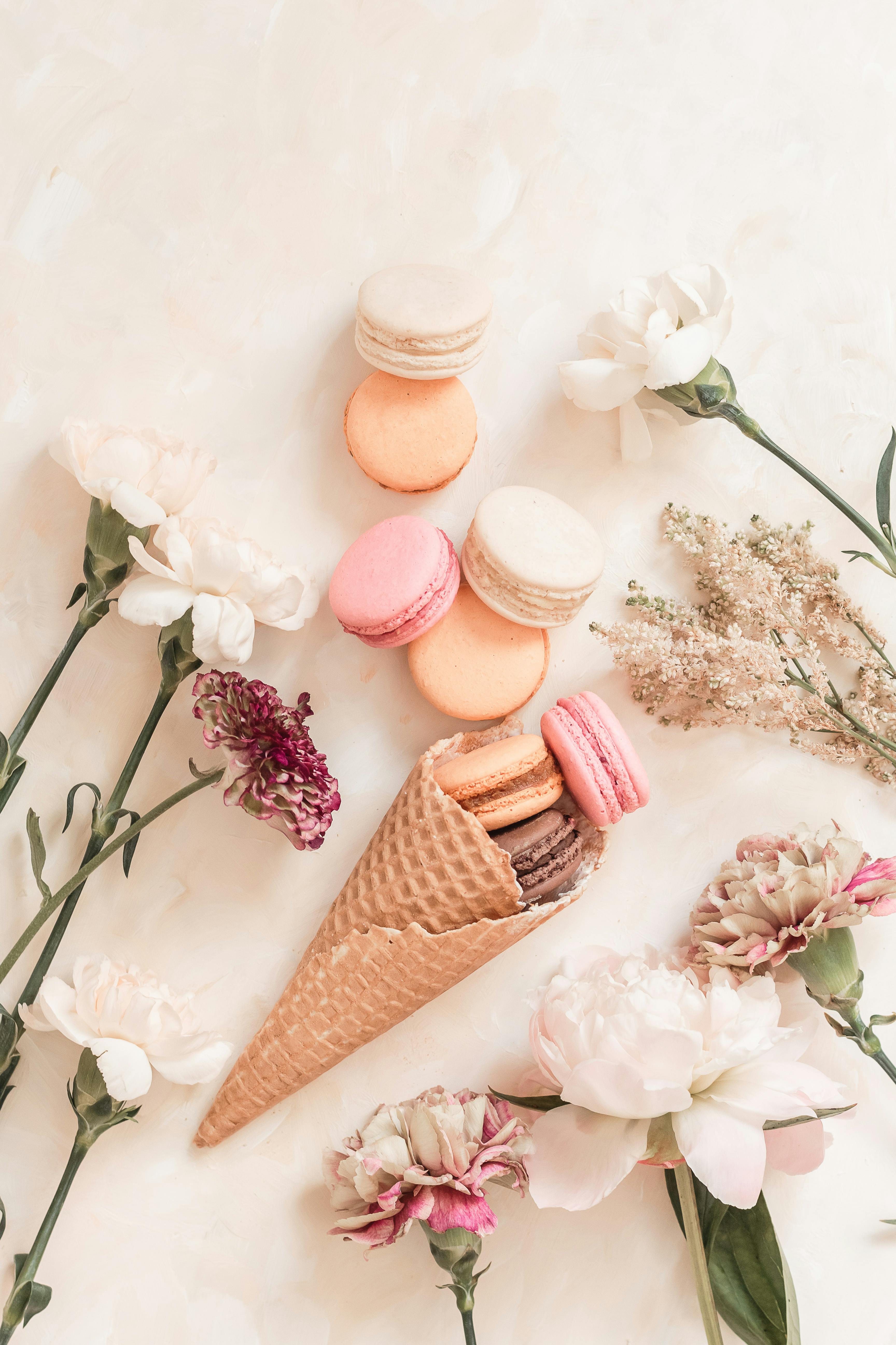 French macarons in a waffle cone with flowers